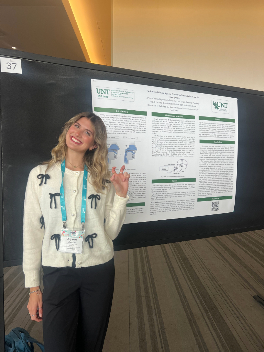 ASLP undergraduate student standing next to her research poster