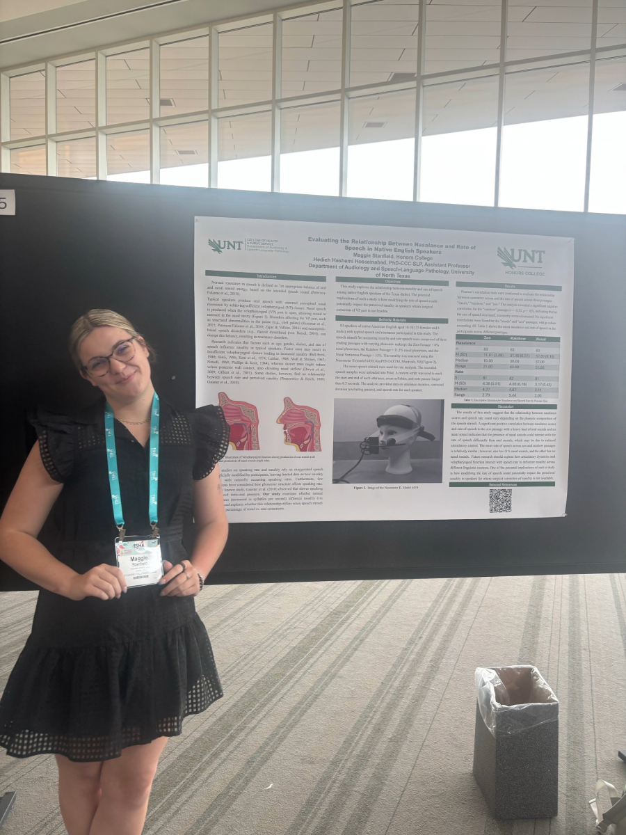 ASLP undergraduate student next to her research poster