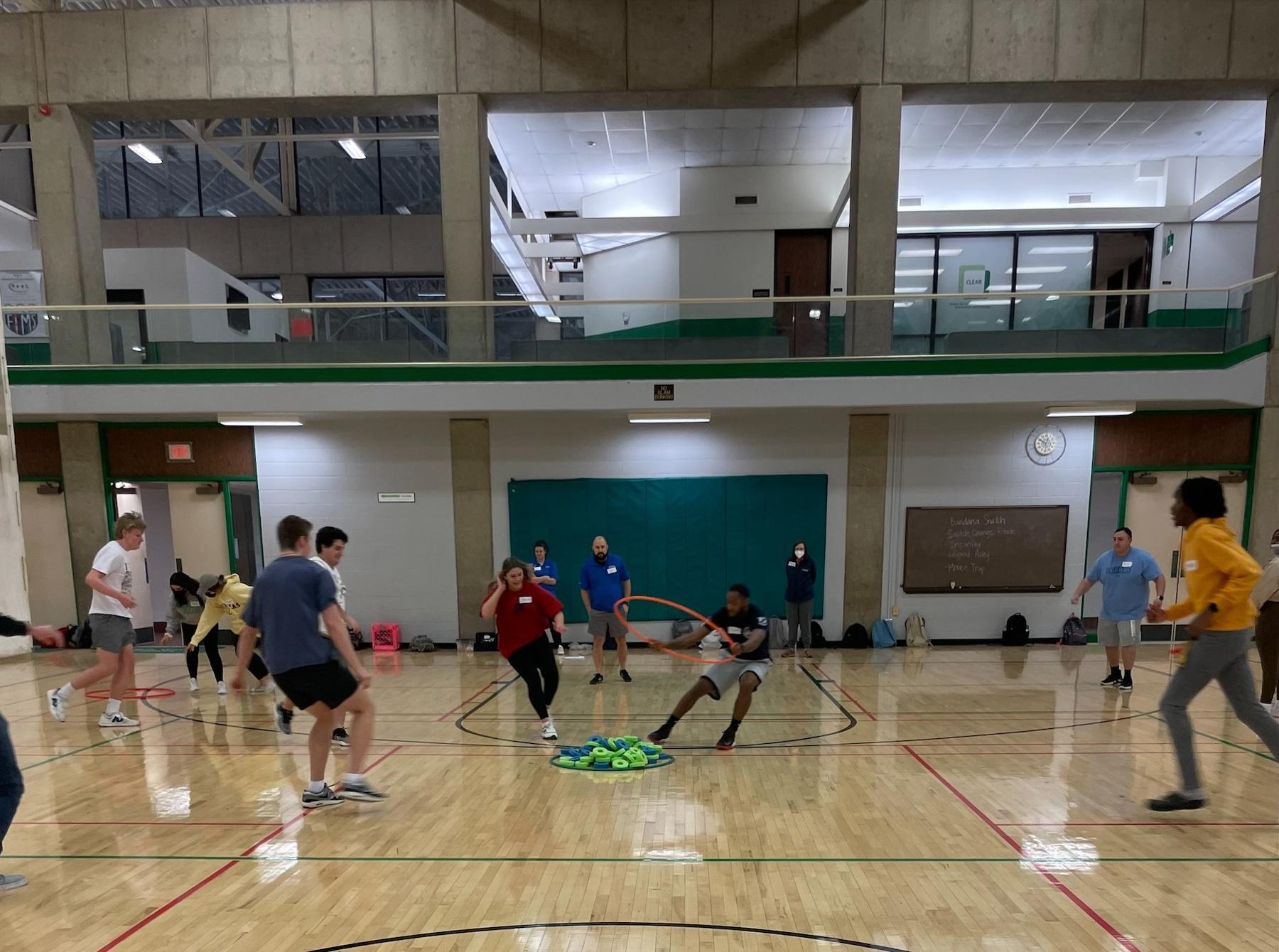 People running in a gymnasium