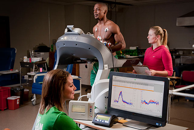 Women working with man on a treadmill