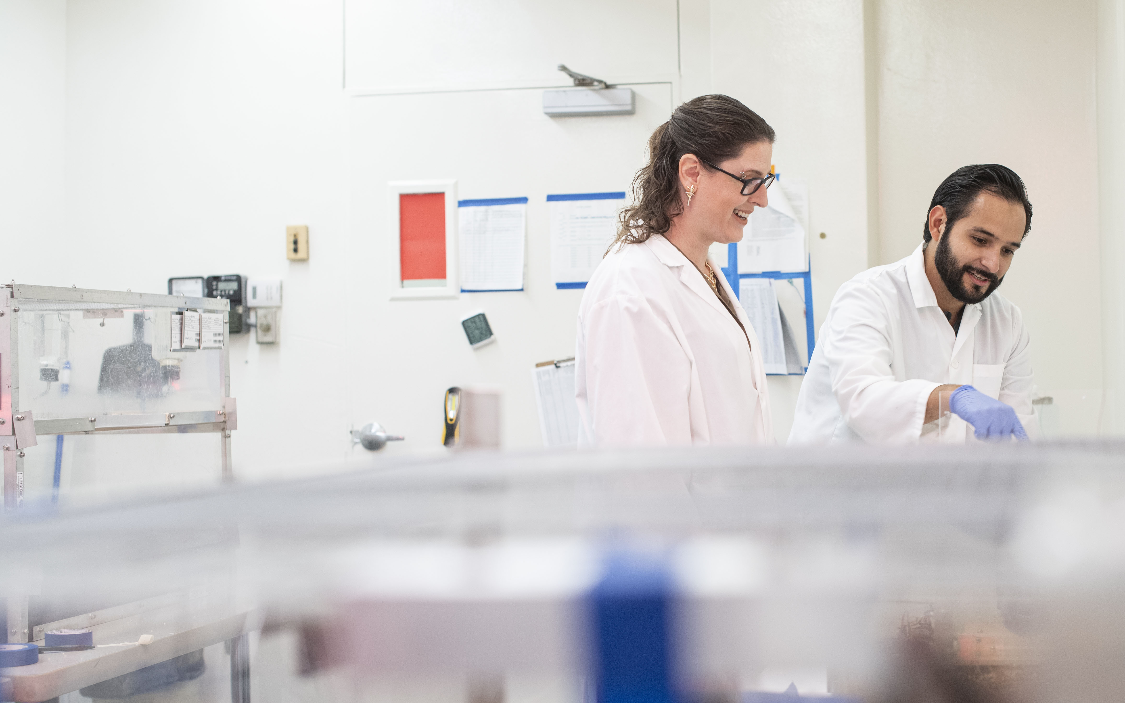 April Becker and male graduate student completing research in lab