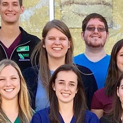 Doctor of Audiology students standing together on the steps of the UNT Speech and Hearing Center