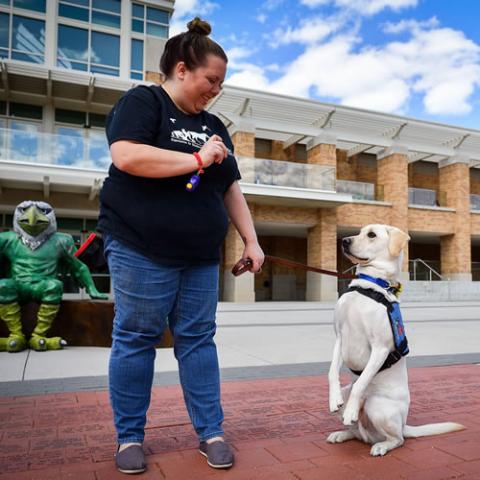 Woman training a service dog