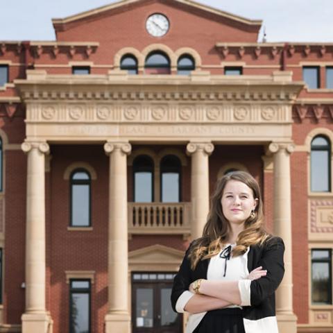 MPA alumna standing in front of a city hall building