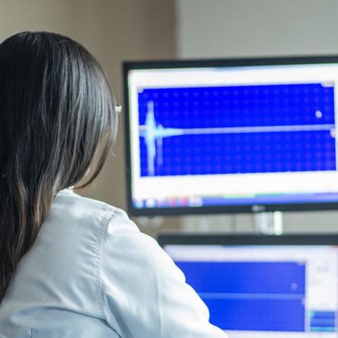 Woman looking at health data on a computer screen