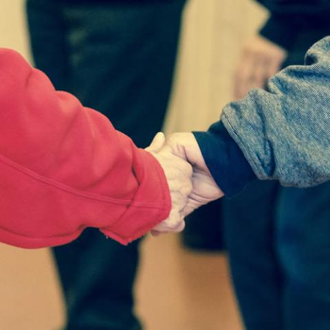 Members of an older population holding hands