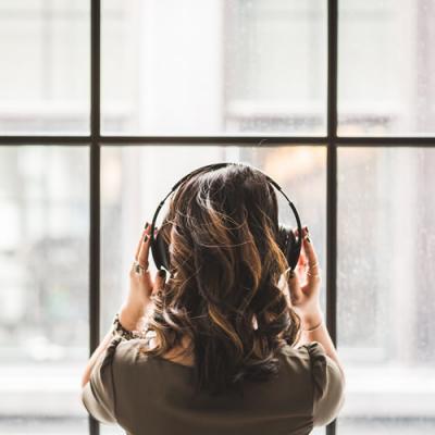 Woman putting headphones on herself