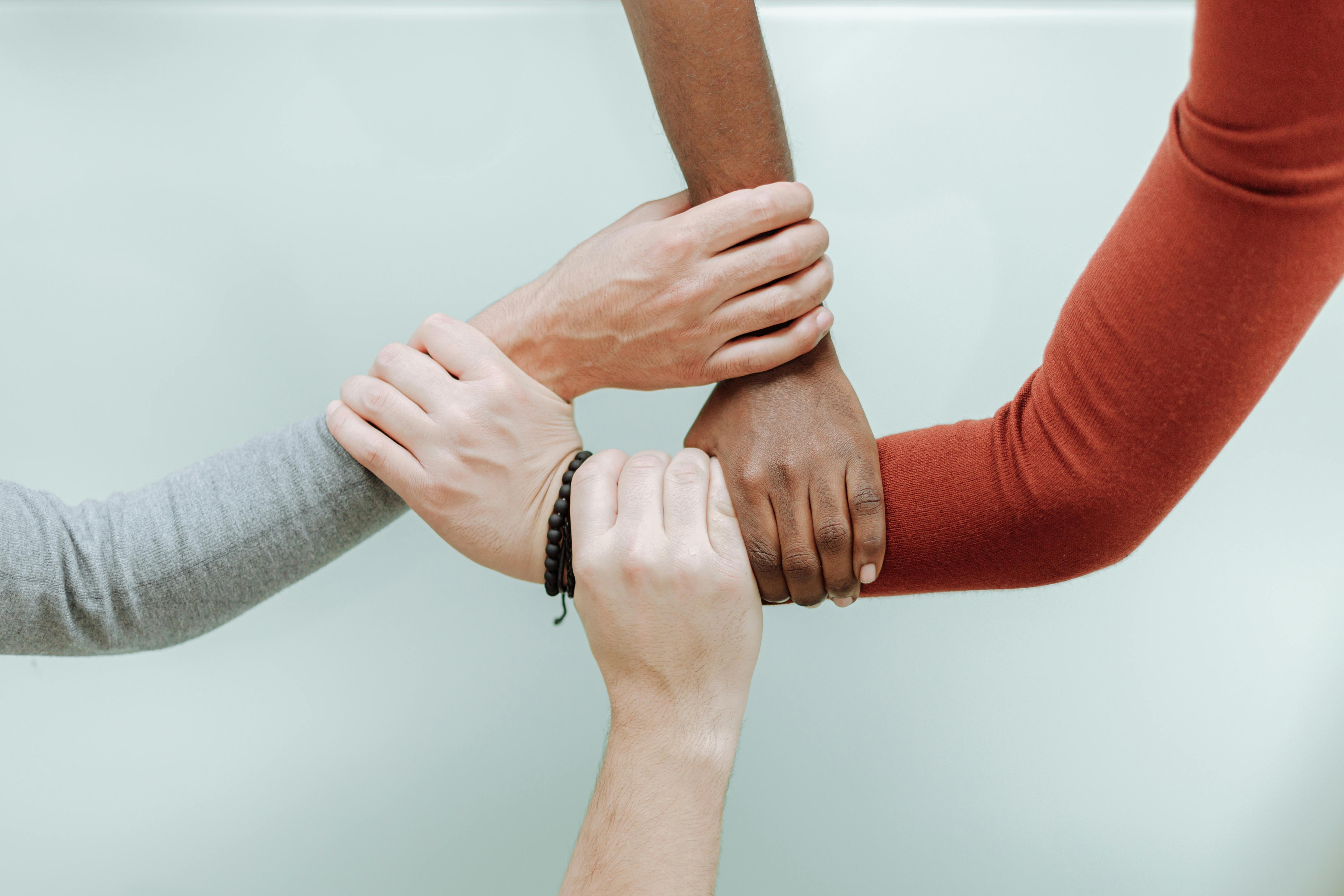 People of various races holding hands