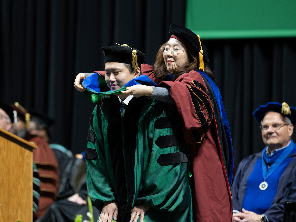 Student being hooded at a graduate ceremony